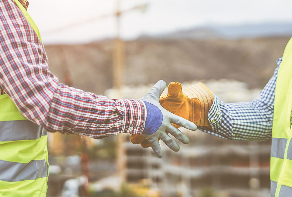 Contractors shaking hands at a job site