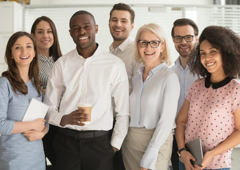 Smiling group of employees in Mansfield, LA covered by commercial insurance