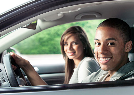 Young couple driving with auto insurance in Bossier City